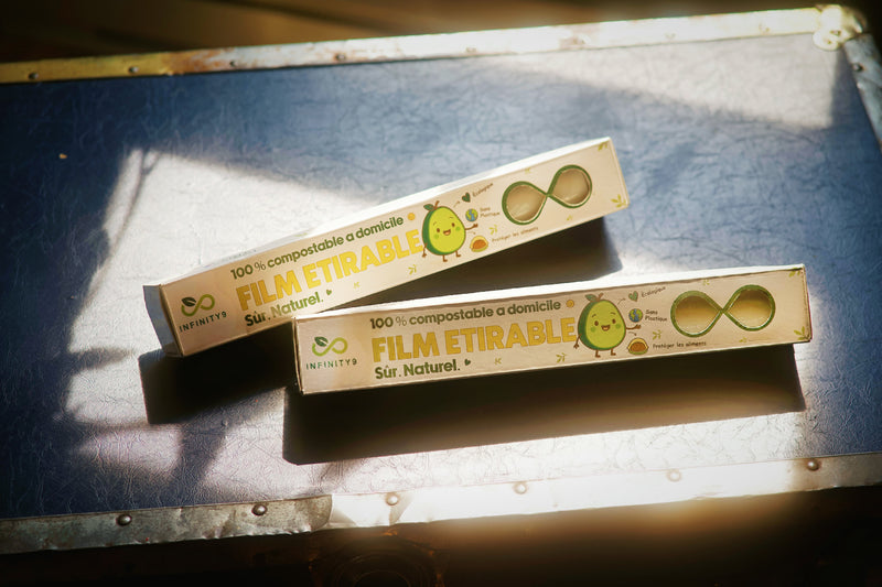 Two Infinity9 eco-friendly cling-warap packaging boxes on a table surface